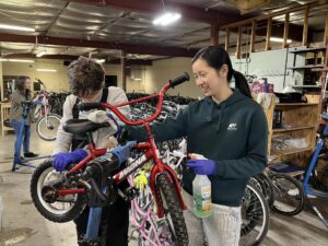 Rotaract volunteers working on a bicycle