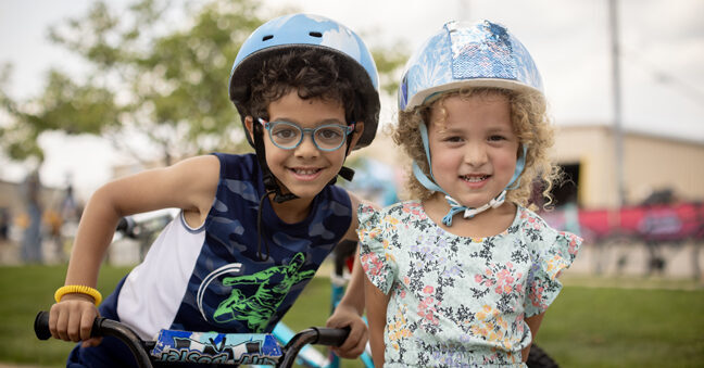 two adorable kids on bikes