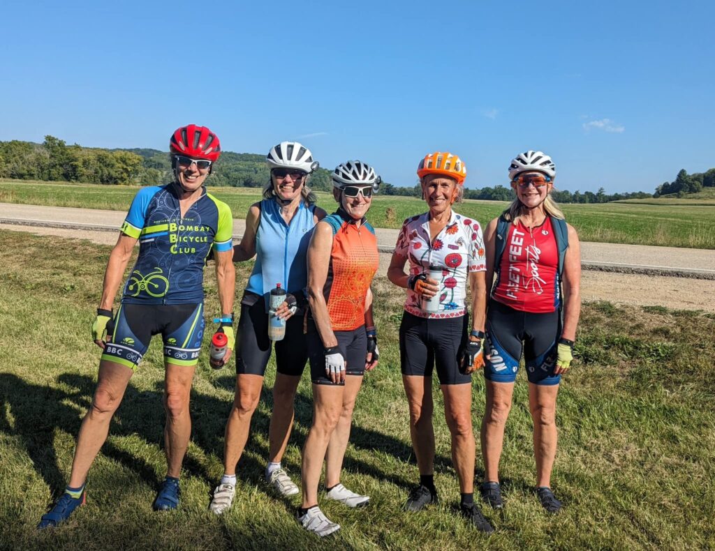 group of riders posing and smiling after the ride