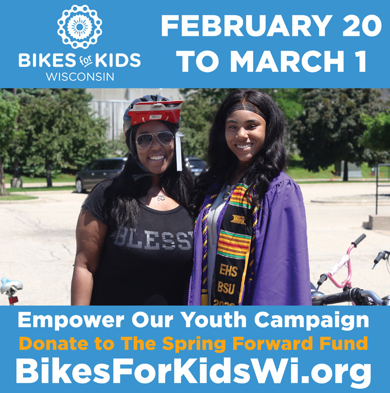 East high graduate in her gown receiving her bike and standing alongside her mom