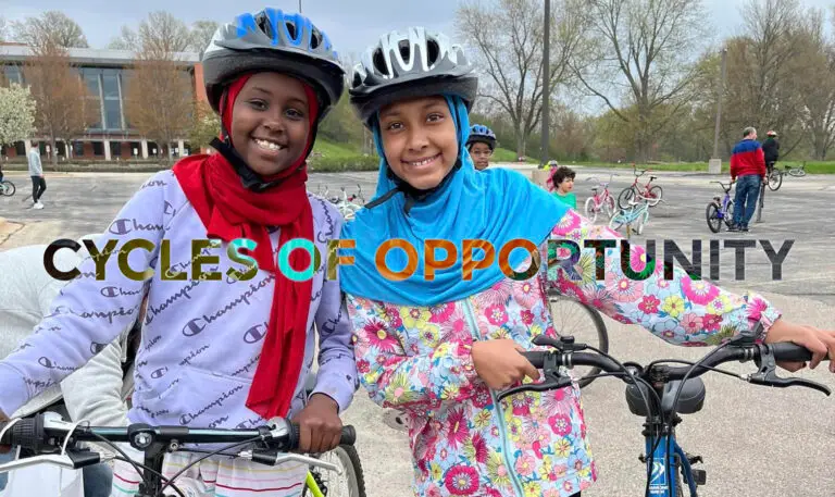 Two high school girls from Madinah Muslim School smiling with their new bikes.