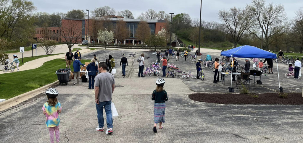 parking lot filled with bikes and people