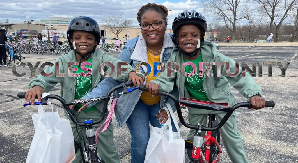 mom and twin boys all receiving new bikes with big smiles