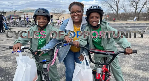 mom and twin boys all receiving new bikes with big smiles